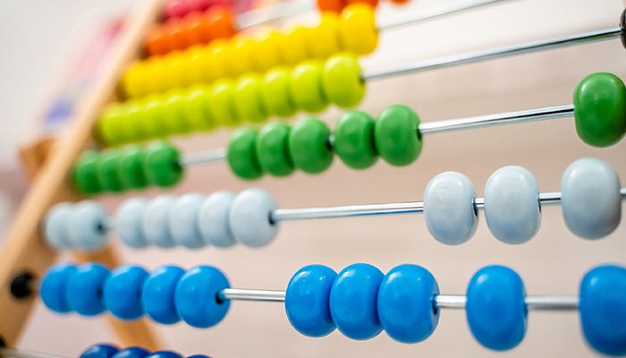 Multicolored beads on an abacus.