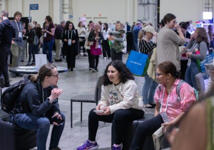 People socializing in a conference exhibit hall